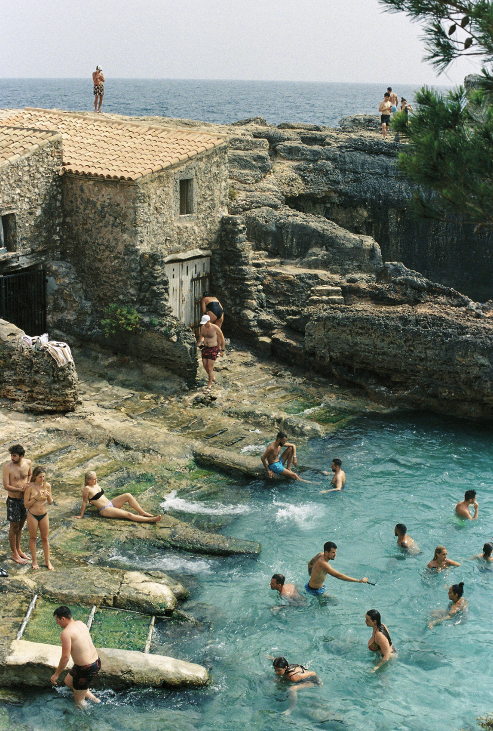 Swimmers in a Mediterranean rock cove