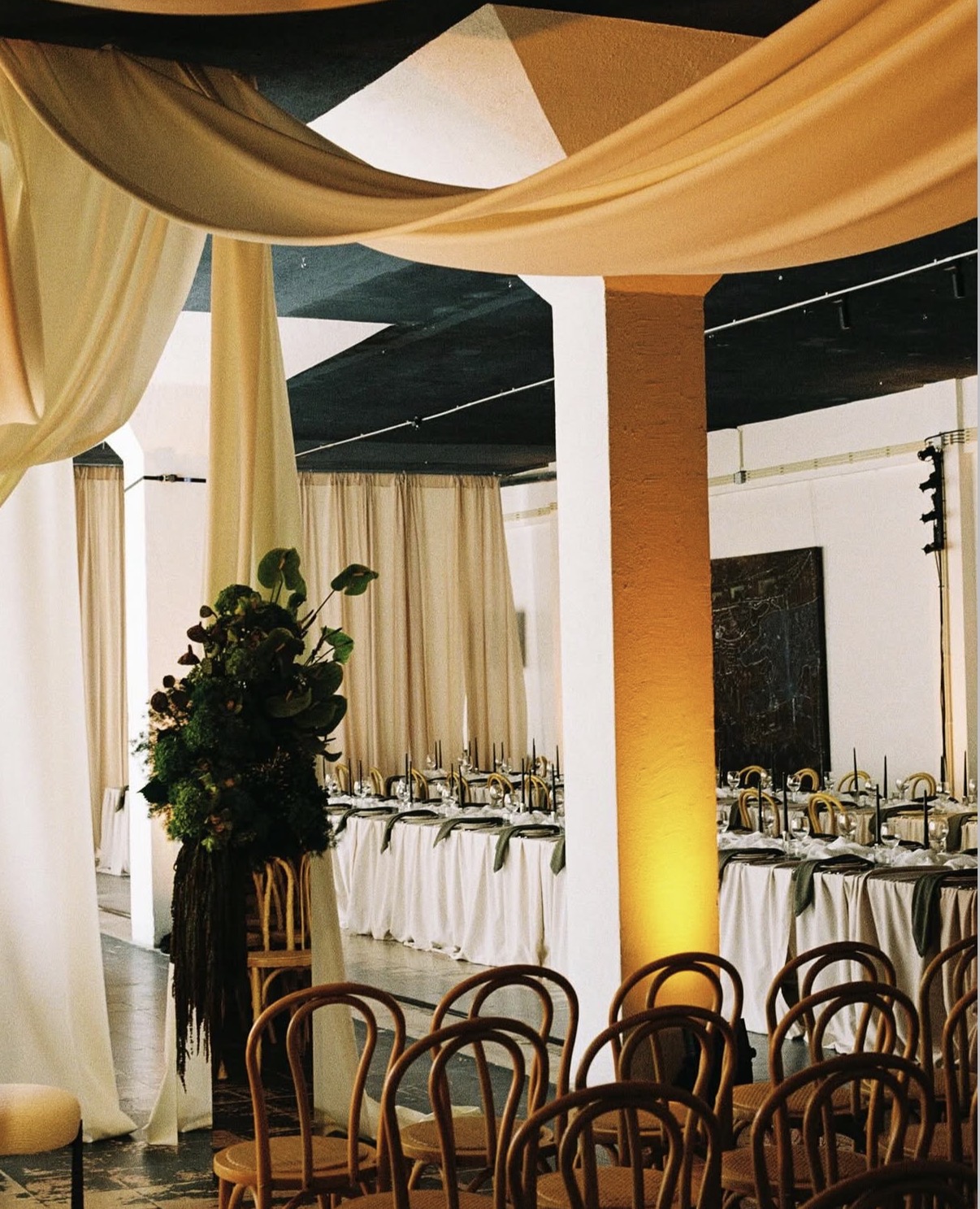 Draped event space set for dinner